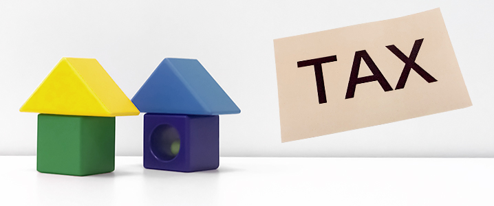建物模型とTAXの文字により相続税を表したイメージ画像